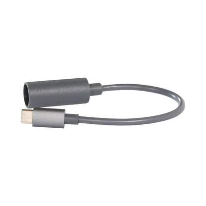 Starlink Mini female/DC to USB-C male power lead coiled beside satellite dish