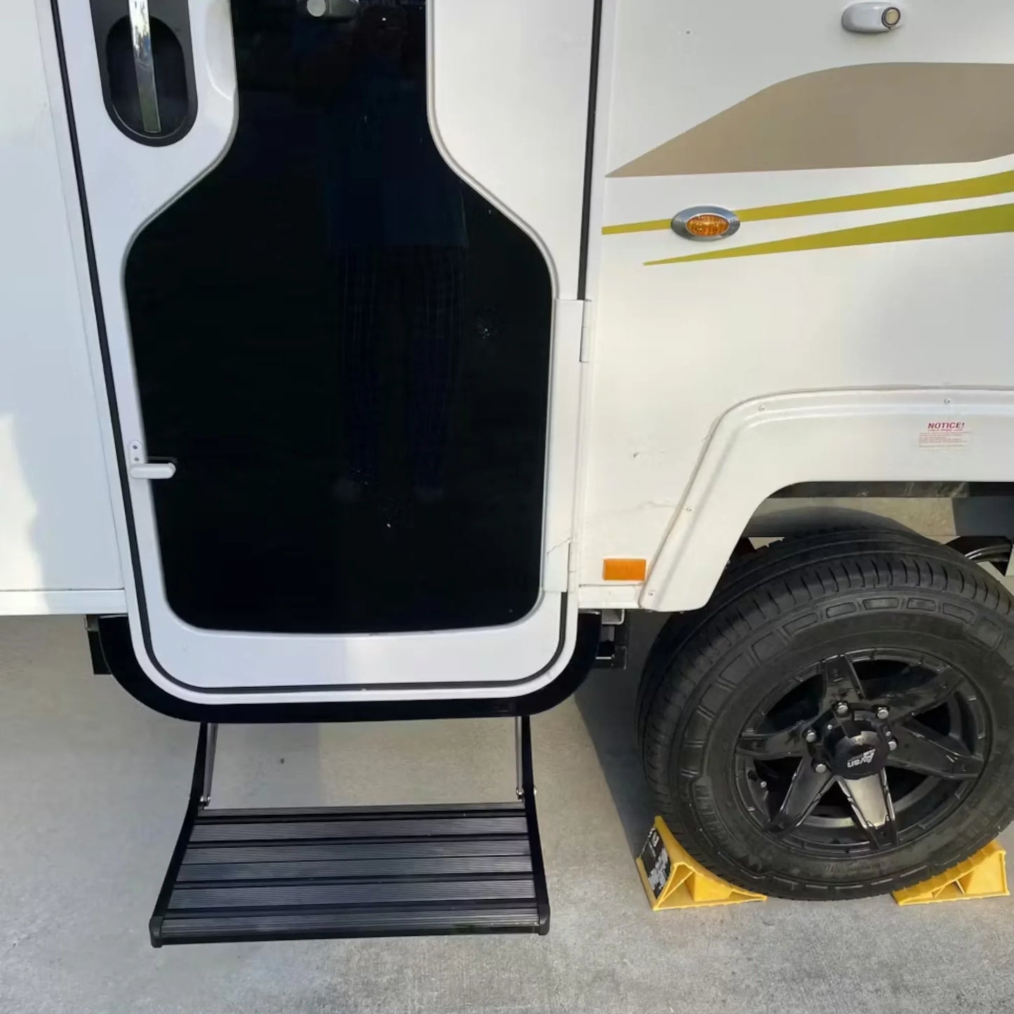 Black single manual caravan step for caravan, rv, and campervan entry access